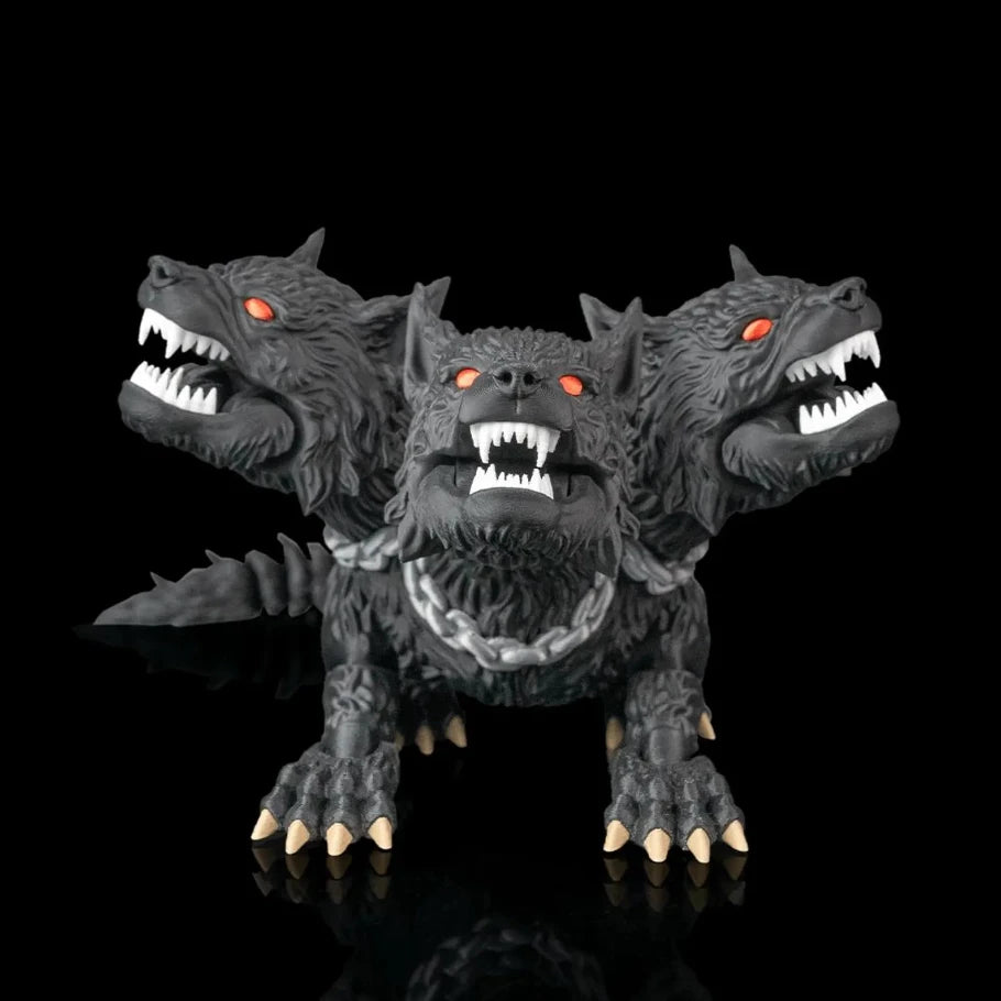 A three-headed black wolf or monster figurine with glowing red eyes, sharp white teeth, and metallic silver claws, posed against a solid black reflective background.