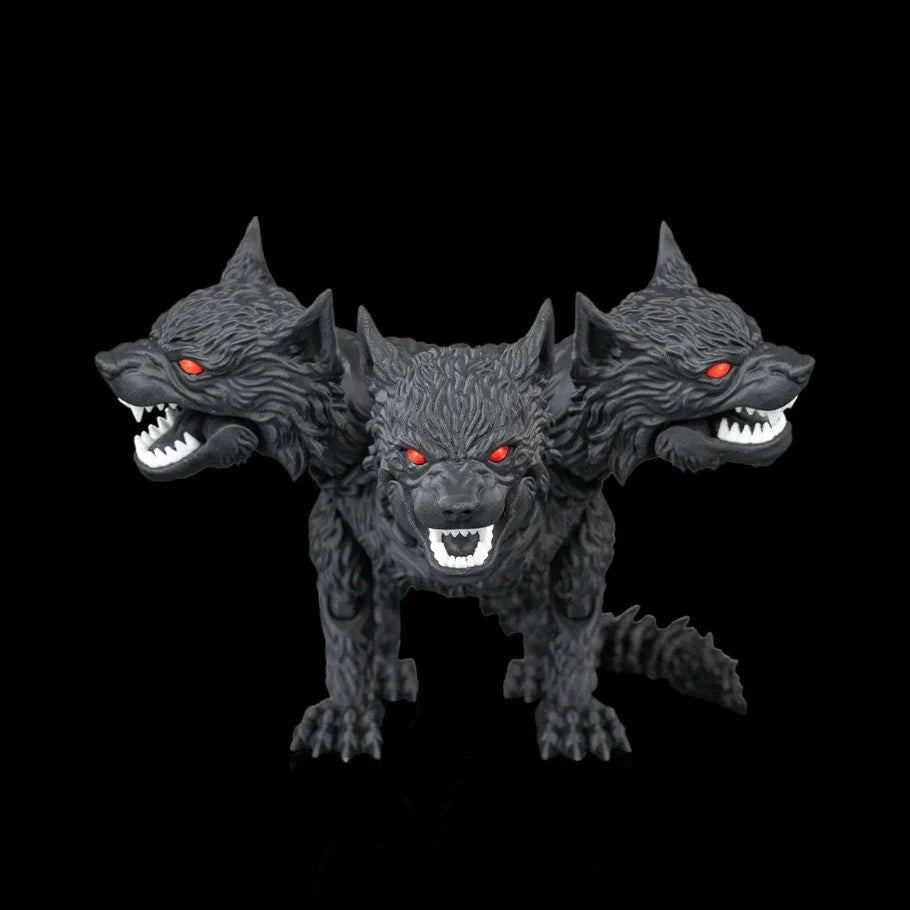 Top view of the three-headed black wolf facing towards glowing red eyes, sharp white teeth, and metallic silver claws, posed against a solid black reflective background.