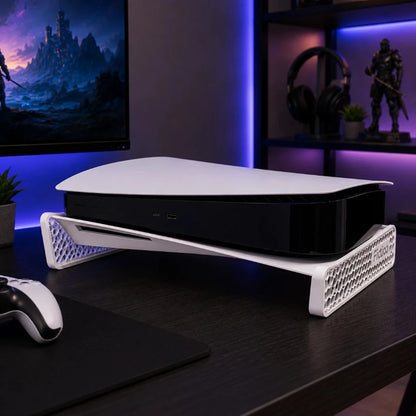 Black gaming console on a white stand with a dark background and gaming setup.