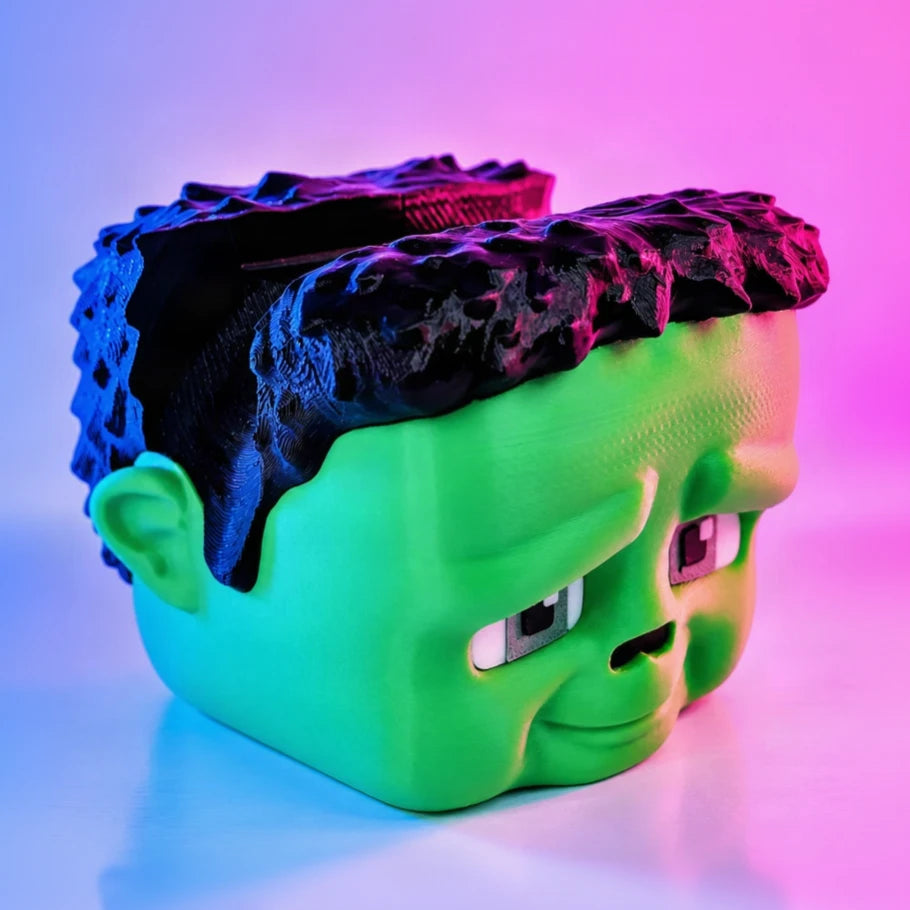 Kawaii green Frankenstein head controller stand in neon lighting - Fictioo