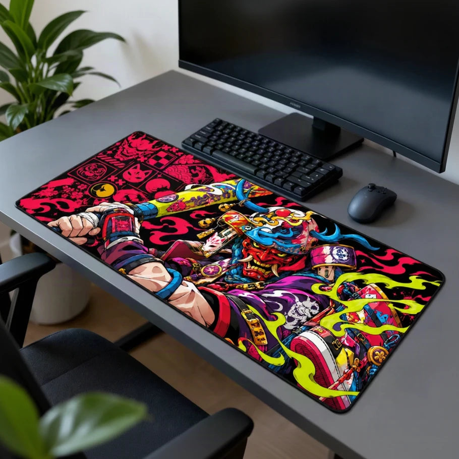 Neon Oni Samurai gaming deskmat featuring vibrant Japanese-inspired artwork in pink, blue, green and red on a dark grey workstation with plant in background