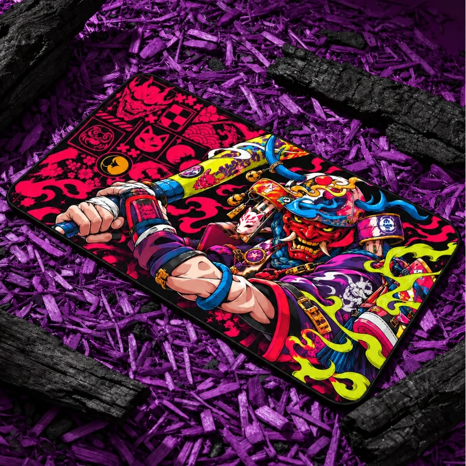 Neon Oni Samurai gaming deskmat featuring vibrant Japanese-inspired artwork in pink, blue, green and red on a black base, displayed on purple wood chips.

