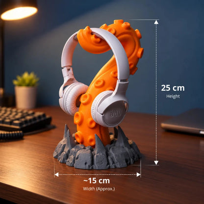 Orange tentacle headphone stand with white JBL headphones, measuring 25 cm in height and approximately 15 cm in width.