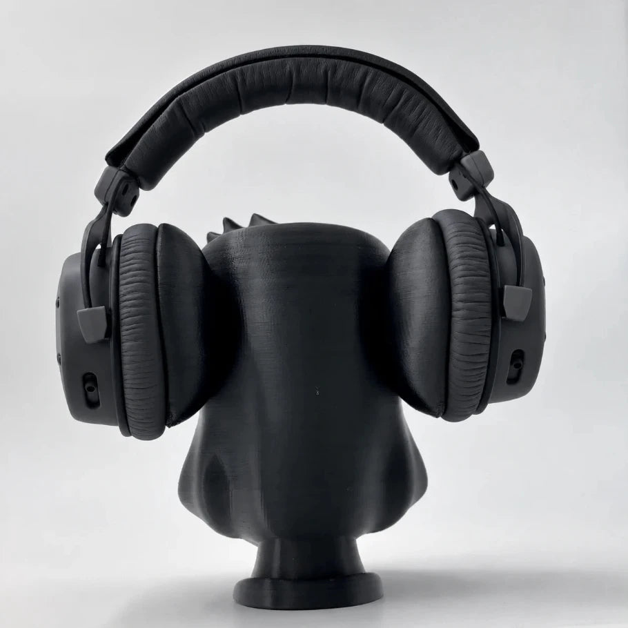 Rear view of the Zen Gorilla headphone stand with black over-ear headphones resting on its shoulders