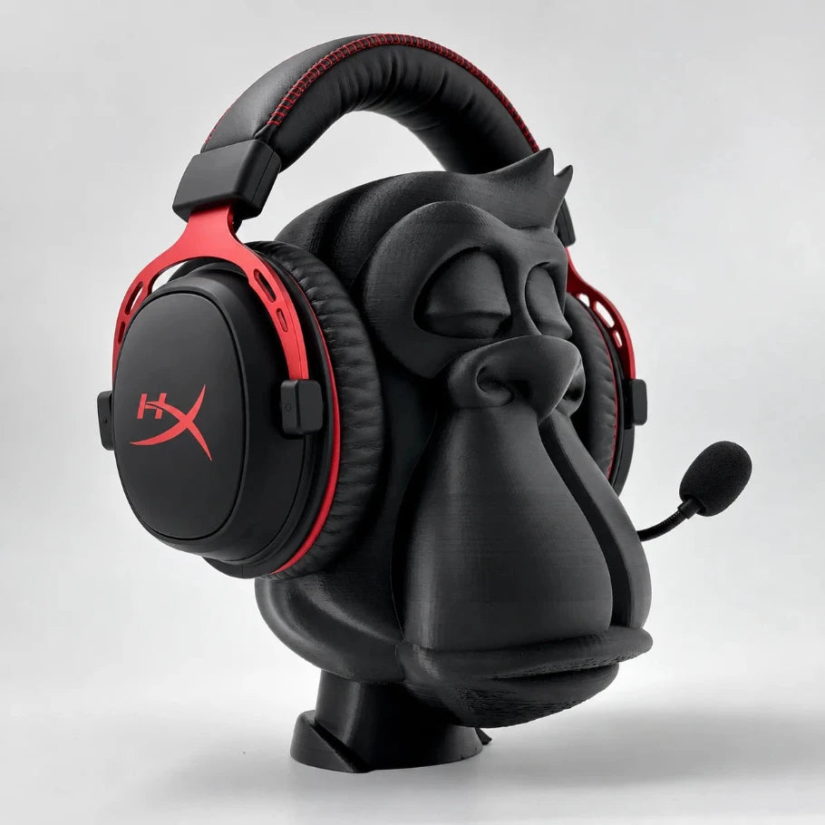 zen gorilla headphone stand holding a red-and-black gaming headset with boom mic, angled view