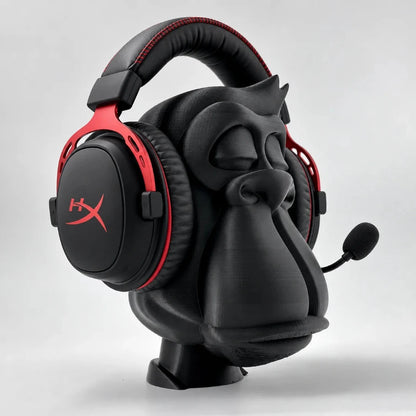 Zen Gorilla headphone stand holding a red-and-black gaming headset with boom mic, angled view