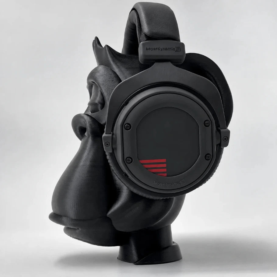 Side profile of the Zen Gorilla headphone stand holding black over-ear studio headphones