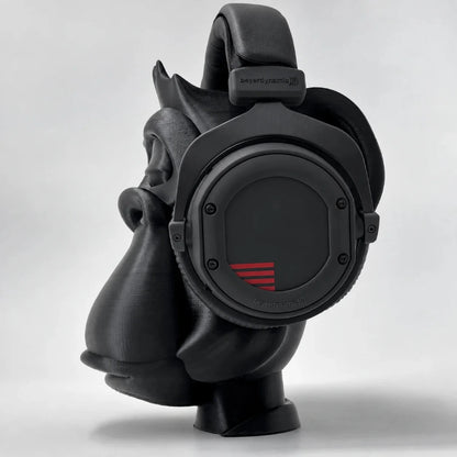 Side profile of the Zen Gorilla headphone stand holding black over-ear studio headphones